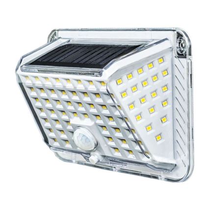 Solárny LED senzorový reflektor svieti. Obsahuje solárny panel a množstvo LED diód. Je umiestnený na stene.