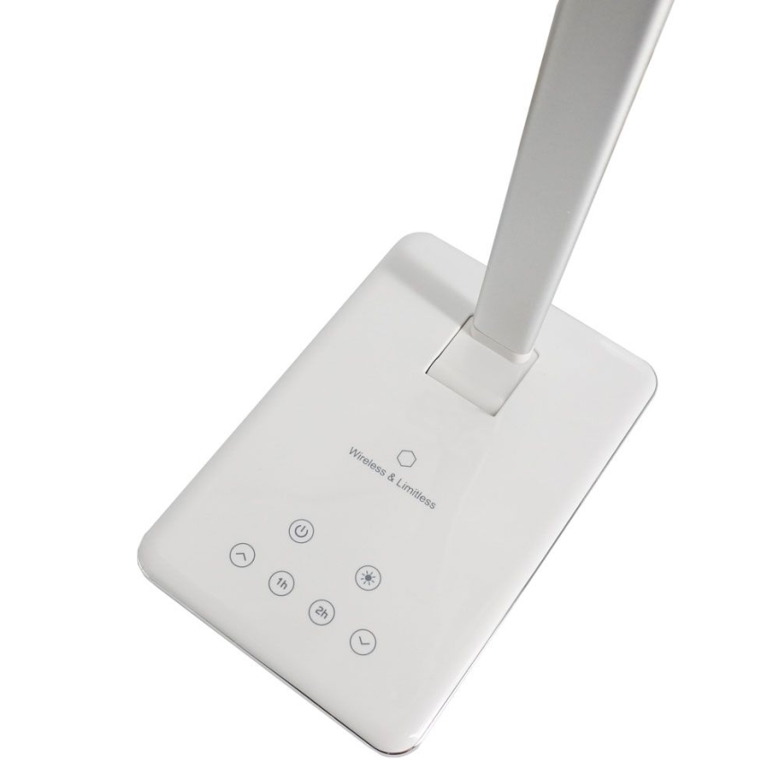 Biela stolová lampa stojí na obdĺžnikovej základni. Základňa obsahuje ovládacie tlačidlá: zapínanie/vypínanie, nastavenie jasu, časovač (1h a 2h). Na základni je text: „Wireless & Limitless“.