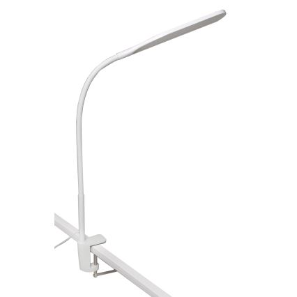 Biela stolová lampa s pružnou ramenom a plochým svetelným zdrojom je pripevnená sponou k bielej lište. Lampa svieti.