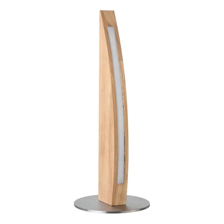 Drevená stolová lampa s integrovaným svetelným zdrojom svieti. Je umiestnená na kovovej podložke a má zakrivený tvar. Lampa je vyrobená z dreva a kovu.