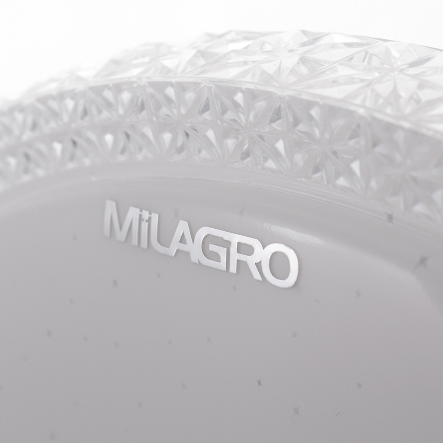 Svetlošedý predmet s vyrytým nápisom MILAGRO má ozdobný, číry, fasetový okraj. Je na bielom pozadí.