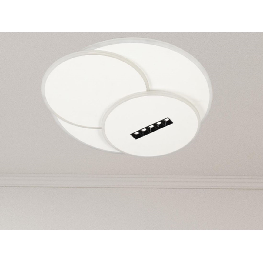 Svietidlo je pripevnené k stropu. Skladá sa z troch prekrývajúcich sa bielych kruhov s malým čiernym obdĺžnikom obsahujúcim malé otvory, pravdepodobne pre LED diódy, v spodnom kruhu. Strop je svetlosivý s lištou.