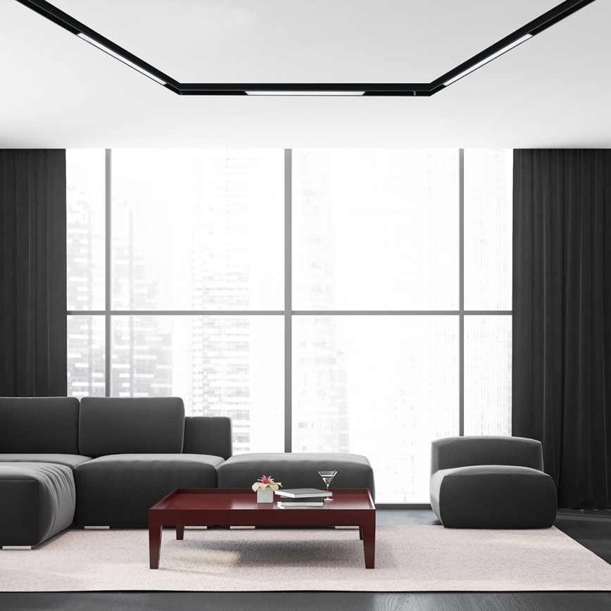 Sivá rohová sedačka stojí v modernej miestnosti pred tmavočerveným konferenčným stolíkom. Miestnosť má veľké okná s výhľadom na mesto a tmavé závesy.