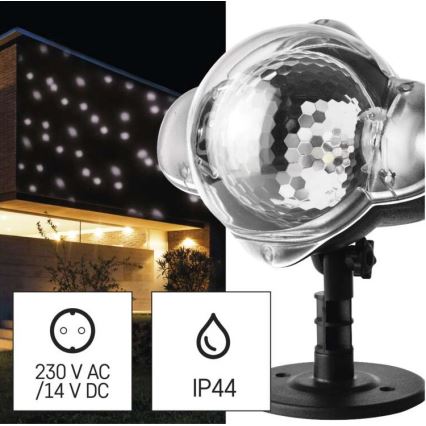 Projektor svieti bodové svetlo na dom. Projektor je umiestnený na stojane. Napájanie: 230 V AC/14 V DC, krytie IP44.