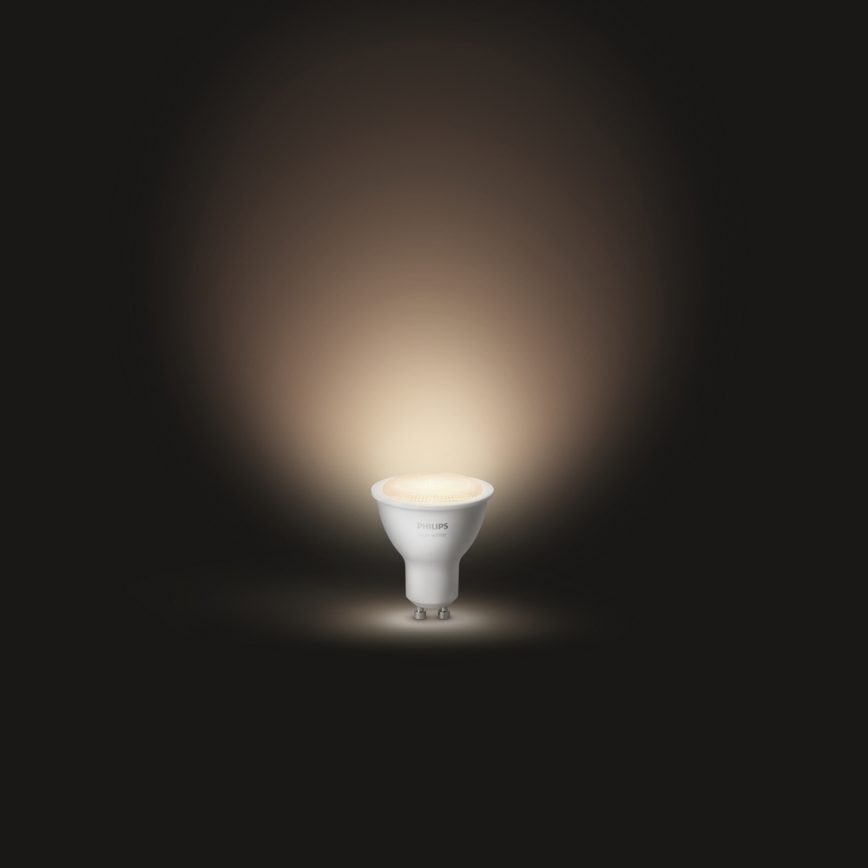 LED žiarovka Philips svieti v tmavom prostredí. Svetlo je teplé, rozlieha sa po okolí.
