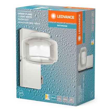 Balenie LED nástennej lampy Orbis Flame, s krytím IP44, obsahuje lampu s priehľadným skleneným tienidlom. Lampa je určená do kúpeľne a má technické parametre: 435 lm, 5,5 W, 3000-4000 K, Click-CCT. Záruka 5 rokov.