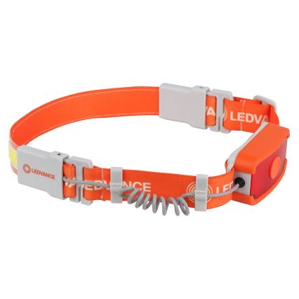 Čelovka oranžovej farby s logom LEDVANCE je pripevnená na nastaviteľnom popruhu. Obsahuje červené svetlo a pruh reflexného materiálu. Popruh je zapínací pomocou plastových spôn.