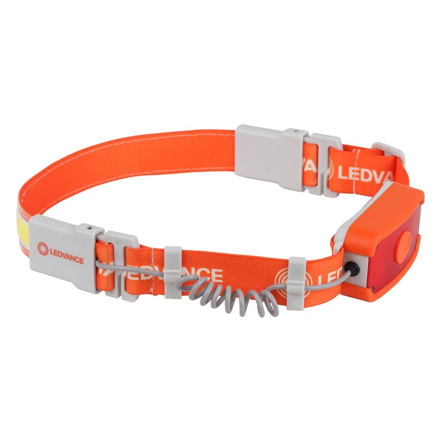 Čelovka oranžovej farby s logom LEDVANCE je pripevnená na nastaviteľnom popruhu. Obsahuje červené svetlo a pruh reflexného materiálu. Popruh je zapínací pomocou plastových spôn.