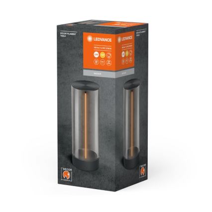 LEDvance stolová lampa s LED osvetlením, v tvare vysokého valca z priehľadného skla s tmavou základňou, je zobrazená na obale. Na obale je uvedené: 105 lm, 1,2 W, 2700 K.