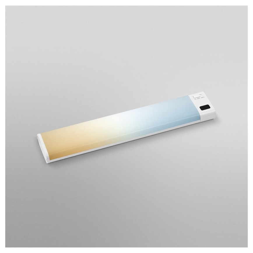 Dlhá tenká LED lampa s prechodom farieb od žltej po modrú leží na svetlošedej ploche. Na jednom konci je malý ovládací panel.