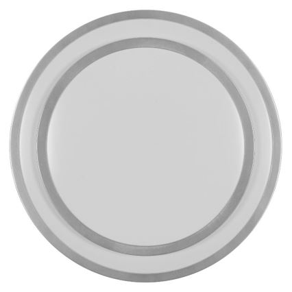 Dve okrúhle taniere sú na sebe. Menší biely tanier je na väčšom bielom tanieri. Oba taniere sú olemované strieborným pásom. Taniere sú na bielom pozadí.