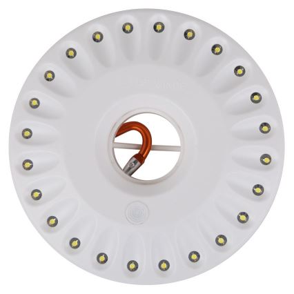 Biela okrúhla LED lampa svieti. Je pripevnená oranžovým háčikom. Lampa má okolo seba 20 LED diód.