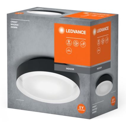 Oválne LED svietidlo s čiernym rámom a bielym difúzorom je zobrazené v balení. Balenie uvádza: LEDVANCE, Orbis Madrid 290mm, E27, max. 2x10W LED, Indoor, 5-ročná záruka.