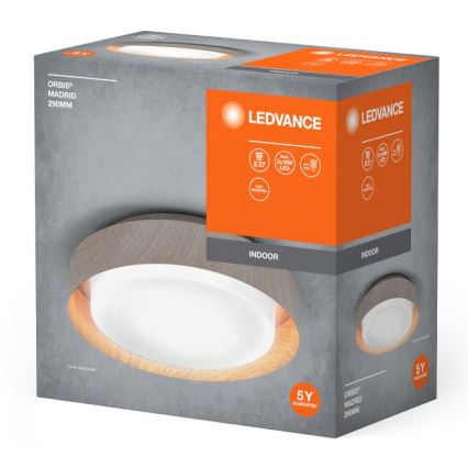Svietidlo LEDvance Orbis Madrid 290mm je zobrazené na obale. Oválny tvar s dreveným rámom, vnútorné svetlo je biele. Balenie uvádza technické parametre: E27, 2x10W LED, vnútorné použitie, 5-ročná záruka.