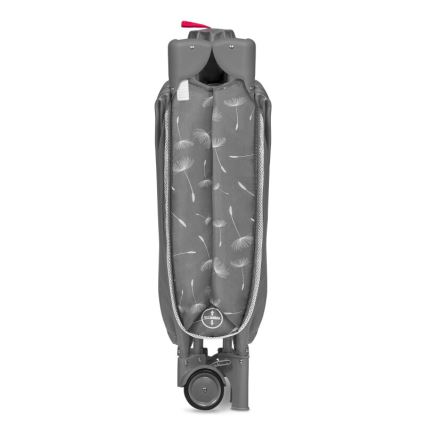 Prebaľovacia taška je zložená, stojí na dvoch kolieskach. Je sivá s bielymi obrázkami púpavy. Má červený detail na vrchu.