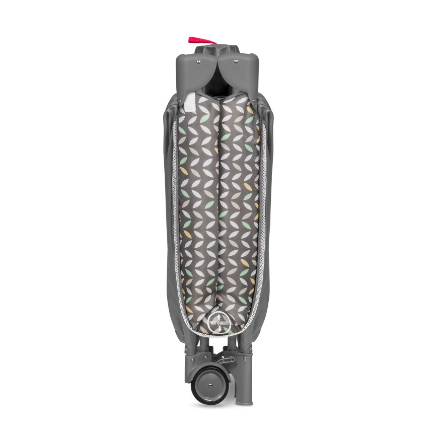 Prebaľovací plienkovač je zložený, má sivú konštrukciu a farebný vzor listov. Je vybavený kolieskami.