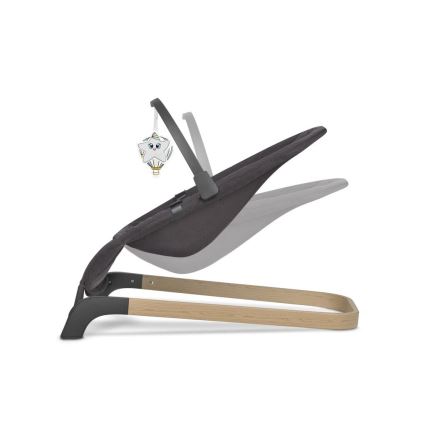 Detská hojdačka s tmavosivou látkovou sedačkou sa nachádza v polohe na nastavovanie sklonu. Sedačka je pripevnená k drevenému a kovovému rámu. Na hojdačke visí hračka v tvare rozprávkového balónu s hviezdičkou.