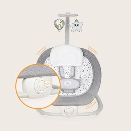 Detská hojdačka sa kýva. Je sivá s bielymi bodkami, má mäkké polstrovanie a hraciu striešku s balónom a hviezdou. Ovládanie je umiestnené na spodnej časti.