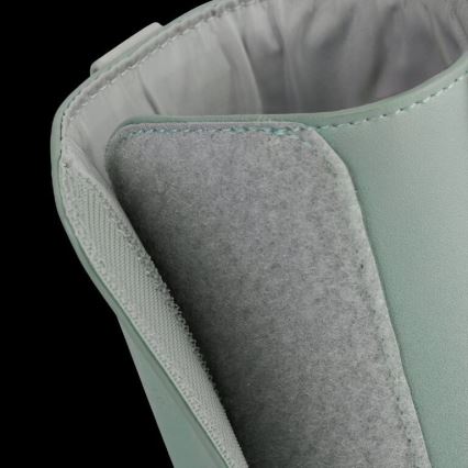 Vnútorná časť svetlomätovej čižmy ukazuje detail suchého zipsu na mäkkom, sivom materiáli pri vnútornom okraji. Čižma je z pevného materiálu, ktorý vytvára kontrast s vnútornou podšívkou.