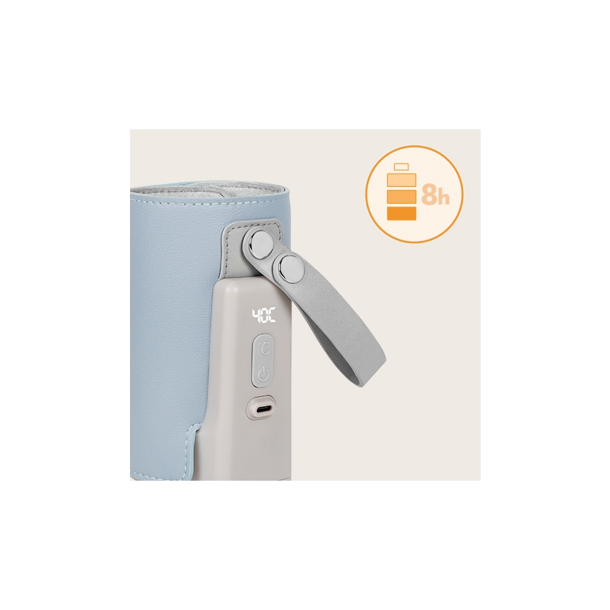 Prenositelný ohrievač fľašiek udržuje teplotu 40°C. Má šedý kryt, kožený remienok a displej s indikáciou teploty. Batéria vydrží 8 hodín.