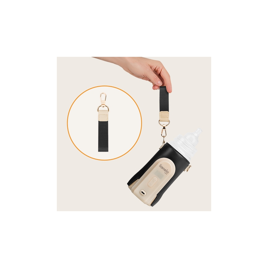 Ruka pripája popruh k fľaši v termotaške lianelo. Taška je béžová s čiernym puzdrom a obsahuje fľašu s cumlíkom. Popruh je čierny s béžovými detailmi a karabínkou.