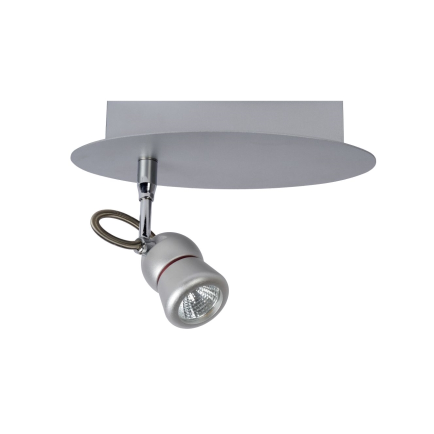 Svietidlo svieti. Je pripevnené k stropnej doske. Doska je okrúhla a striebornej farby.