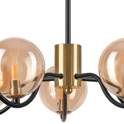Lampa s piatimi guľatými tienidlami z dymovitého skla visí z čierneho kovového ramena. Zlatožltý kovový stredný diel spája tienidlá s čiernymi kovovými ramenami. Svetlá sú vnútri tienidiel.