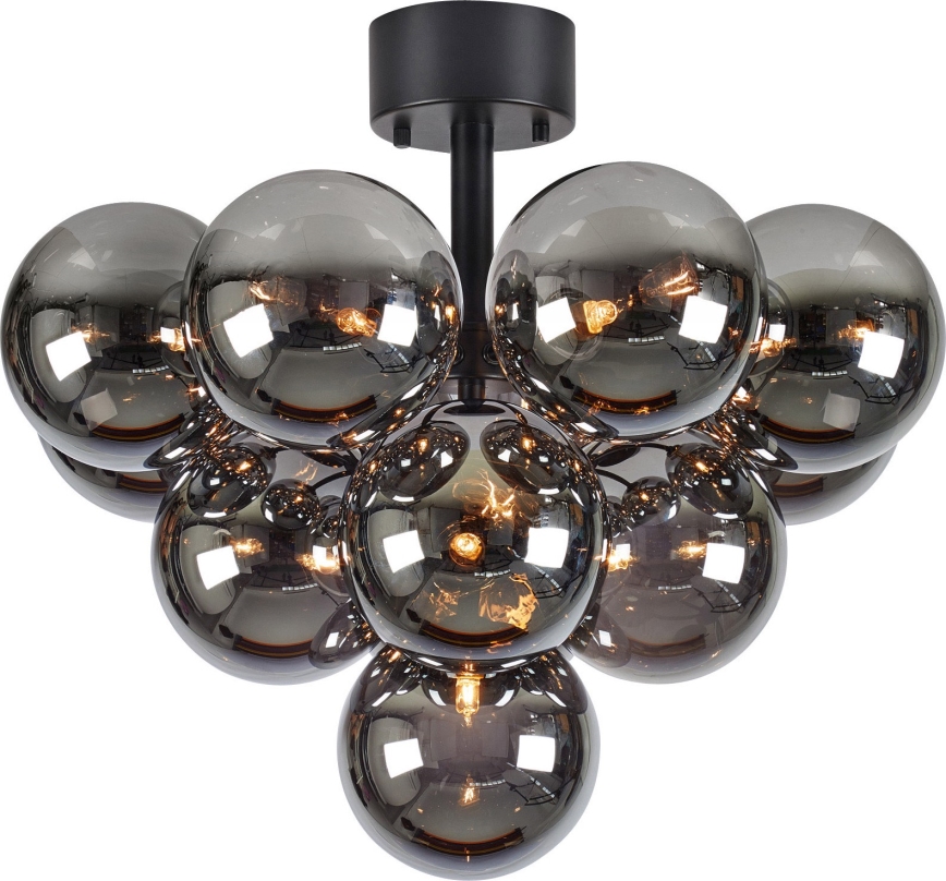 Stropné svietidlo s čiernou kovovou konštrukciou osvetľuje priestor pomocou zoskupenia desiatich tmavosivých sklenených guľôčok s vnútorným zdrojom svetla.