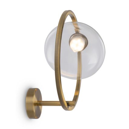Nástenná lampa svieti. Sklenená guľa je obklopená mosadzným kruhom, pripevnená k mosadznej stene. Svetlo vychádza z vnútra sklenenej gule.