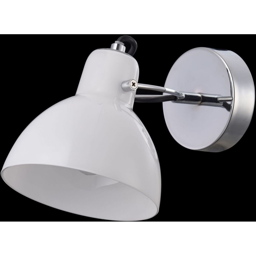 Biela nástenná lampa s kovovou konštrukciou a tienidlom osvetľuje priestor. Lampa je pripevnená k stene pomocou kovového držiaku.