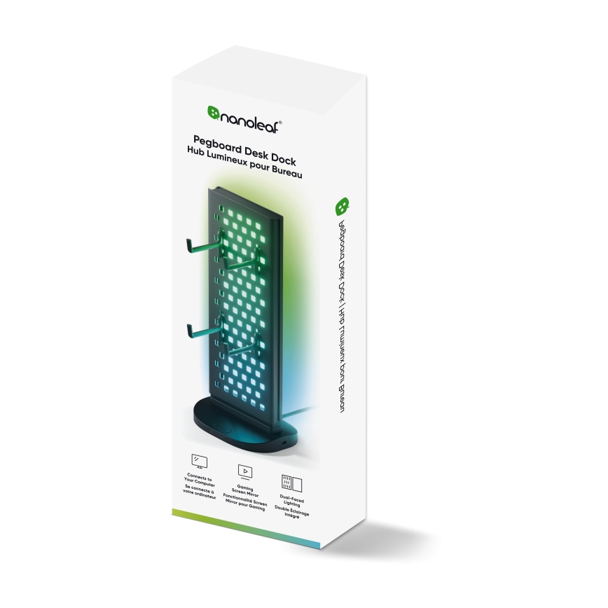 Stojan na stôl s podsvietením Nanoleaf Pegboard Desk Dock stojí na stole. Má háčiky na drôty a podsvietenie. Balenie uvádza názov produktu v angličtine a francúzštine.