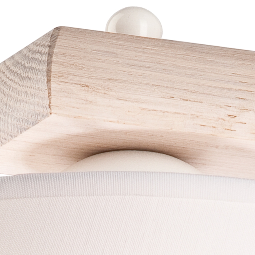 Drevená polica je pripevnená k vertikálne orientovanému drevenému stĺpiku. Pôsobí masívne a je zhotovená z svetlého dreva.