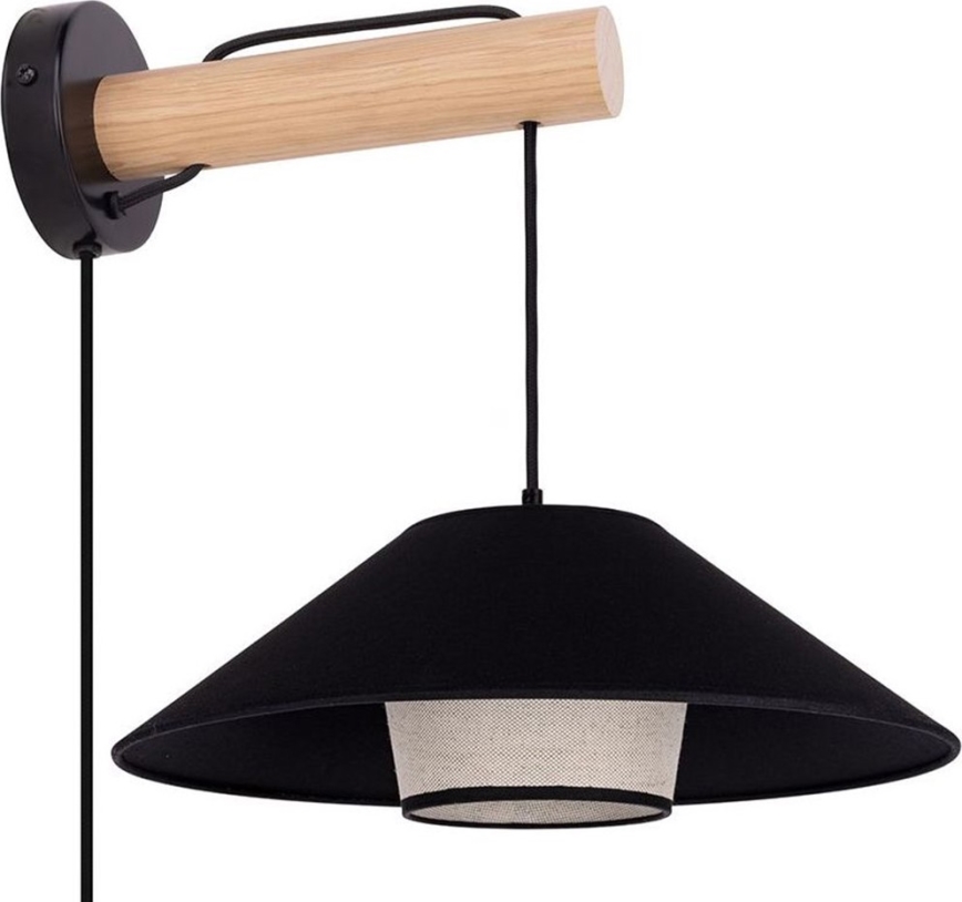 Nástenná lampa s drevenou konzolou a čiernym tienidlom z látky s vnútorným svetlým difúzorom visí z čierneho kábla. Lampa je pripevnená k stene.