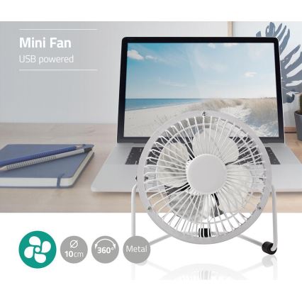 Malý kovový ventilátor s priemerom 10 cm, otáčajúci sa o 360°, je umiestnený na stole pred notebookom. Ventilátor je poháňaný cez USB. Mini Fan, USB powered.