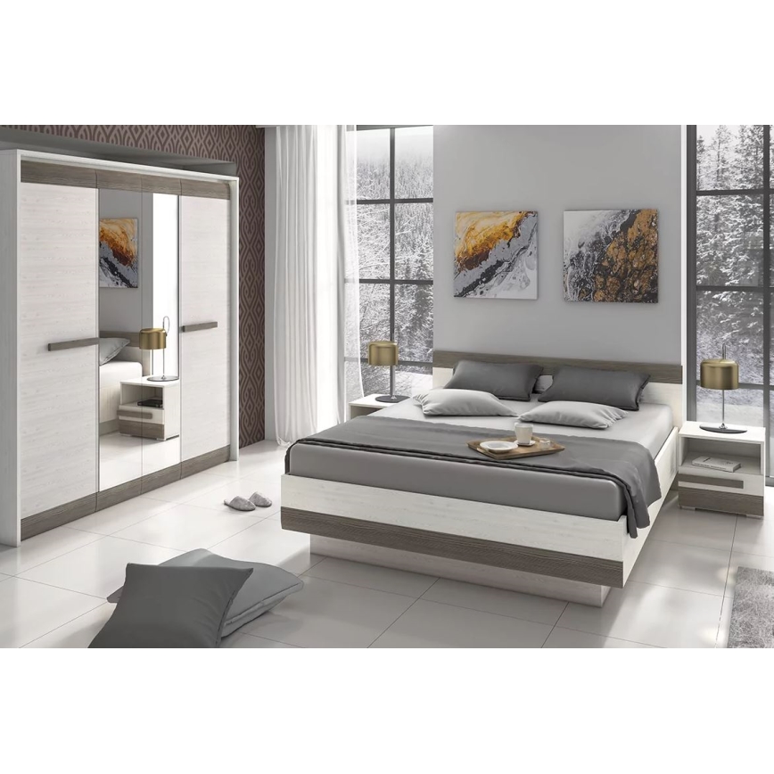 Manželská posteľ s dvomi nočnými stolíkmi a vstavanou skriňou s veľkým zrkadlom sa nachádza v spálni s oknami smerujúcimi do zasneženej krajiny.