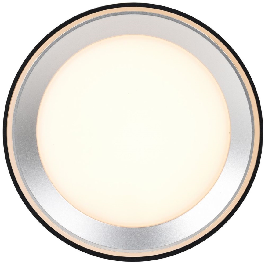 Okrúhle LED svietidlo svieti. Má strieborný a zlatý okraj, vnútornú časť z matného bieleho skla a čierny vonkajší okraj. Je určené na montáž na stenu alebo strop.