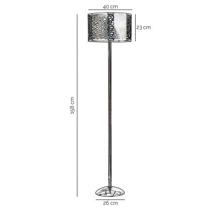 Stojacia lampa s vysokou kovovou nohou a valcovým tienidlom s geometrickým vzorom stojí na podstavci. Tienidlo má priemer 40 cm a výšku 23 cm. Celková výška lampy je 158 cm, priemer podstavca je 26 cm.