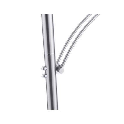 Stojanová lampa s kovovou konštrukciou, má ohnuté rameno, je pripevnené k stĺpiku pomocou skrutiek. Lampa je zrejme striebornej farby.