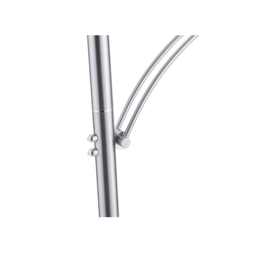 Stojanová lampa s kovovou konštrukciou, má ohnuté rameno, je pripevnené k stĺpiku pomocou skrutiek. Lampa je zrejme striebornej farby.