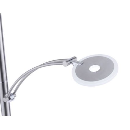 Stojacia lampa s kovovou konštrukciou a okrúhlou LED hlavicou svietidla, ktorá je pripevnená k výsuvnému rameni. Lampa je striebornej farby.