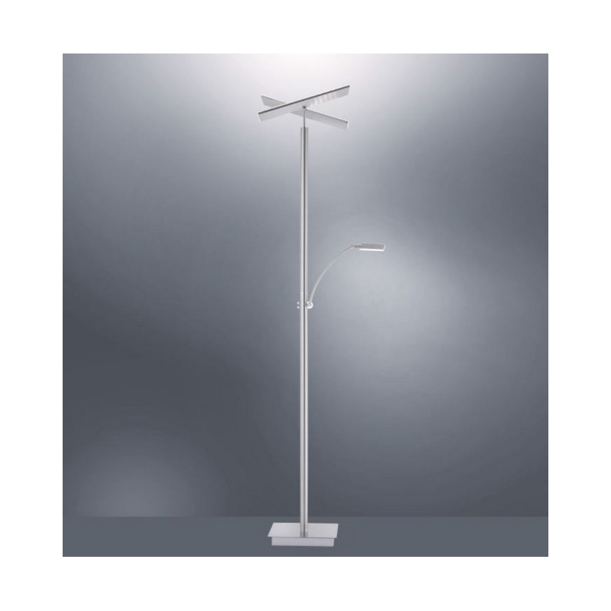 Stojacia lampa s dvoma LED svetlami, jedno horné v tvare kríža a jedno menšie bočné na výklopnej ramienku, stojí na štvorcovej základni pred sivým pozadím.