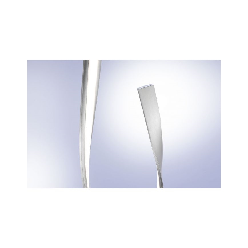 Dve kovové lišty, z ktorých jedna je zakrivená a druhá je skrútená, sa nachádzajú na svetlomodrom pozadí.