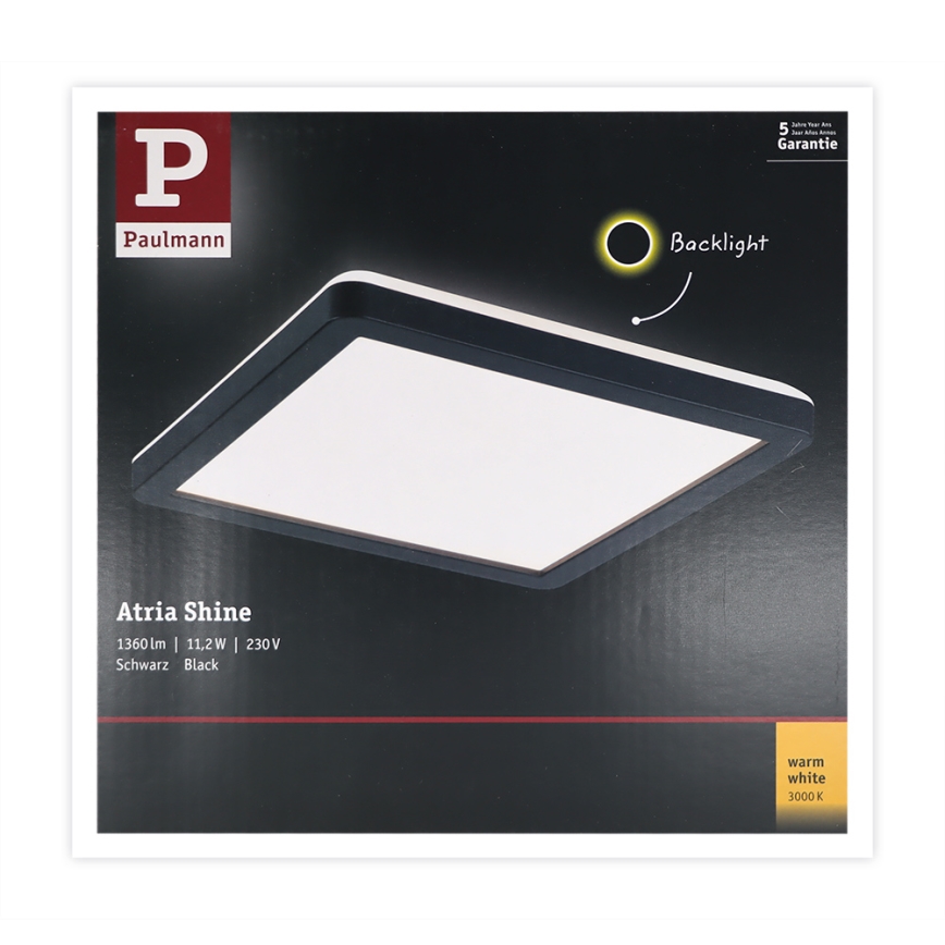Štvorcové svietidlo Atria Shine od Paulmann svieti. Má čierny rám a teplú bielu farbu svetla (3000 K), výkon 11,2W a svetelný tok 1360 lm. Balenie ukazuje svietidlo s podsvietením.
