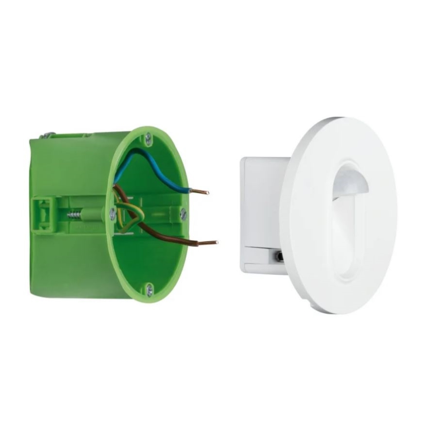 Senzor pohybu s LED svetlom sa montuje do zelenej plastovej nástennej krabice s pripojenými vodičmi. Biely senzor je navrhnutý na zapustenú montáž.