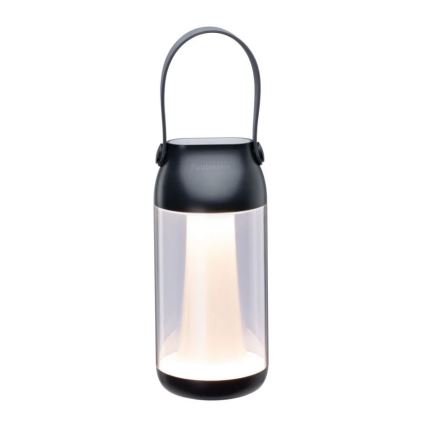 Prenositeľná lampa s čiernym plastovým telom a čírym skleneným stredom svieti. Má horný čierny kryt s úchytkou a nápisom „Fadaleon“. Lampa stojí na bielom pozadí.