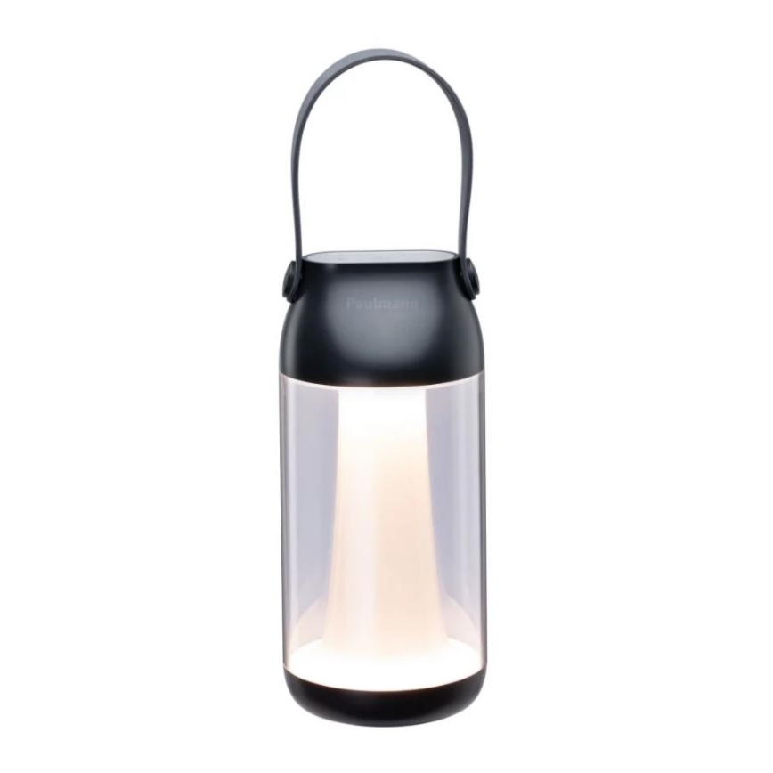 Prenositeľná lampa s čiernym plastovým telom a čírym skleneným stredom svieti. Má horný čierny kryt s úchytkou a nápisom „Fadaleon“. Lampa stojí na bielom pozadí.