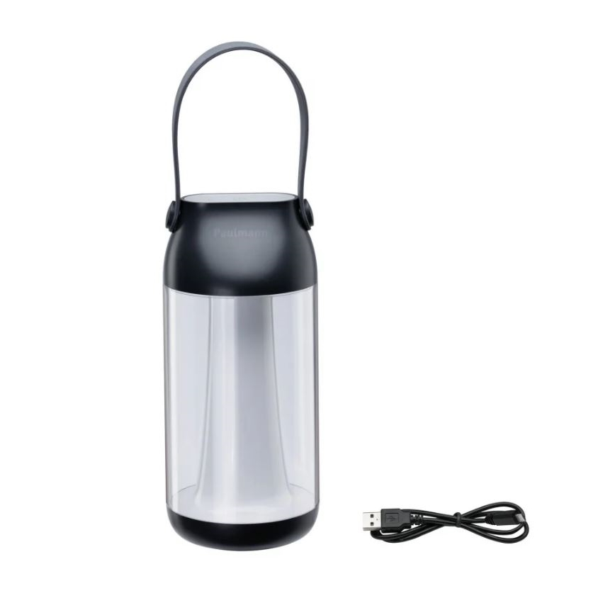 Prenositelná lampa s rukoväťou svieti. Je z tmavošedej a priehľadnej plastovej časti. K lampe patrí USB kábel na nabíjanie. Na vrchnej tmavošedej časti je logo „Paulmann“.