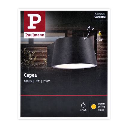 Čierna vonkajšia nástenná lampa Capea od Paulmann svieti na tehlovú stenu. Lampa má valcový tienidlo a parametre: 600lm, 6W, 230V, IP44, 3000K. Záruka 5 rokov.
