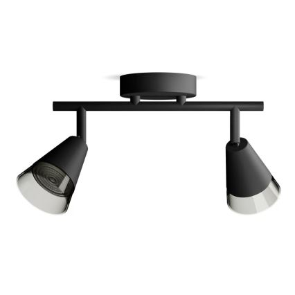 Dvojité svietidlo s čiernym kovovým ramenom a kužeľovitými tienidlami z matného čierneho kovu s priesvitnými difúzormi je pripevnené k stropu. Svietidlo osvetľuje.