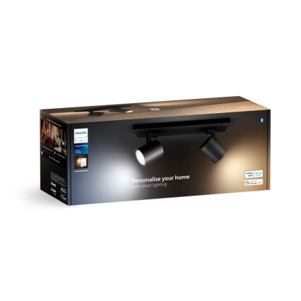 Balenie s dvoma čiernymi bodovými svetlami na lište predstavuje inteligentné osvetlenie. Balenie zobrazuje svetlá osvetľujúce priestor. Text na balení: „Personalise your home with smart lighting“.